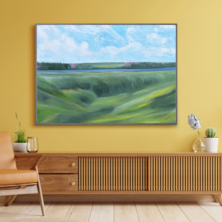 Acrylic painting on canvas, depicting a calm green meadow stretching toward a river. On the other side, a forested area hides distant pink-roofed houses beneath a bright sky filled with soft clouds.