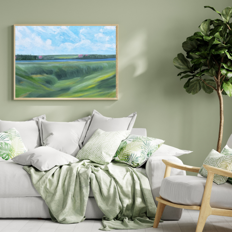 Acrylic painting on canvas, depicting a calm green meadow stretching toward a river. On the other side, a forested area hides distant pink-roofed houses beneath a bright sky filled with soft clouds.