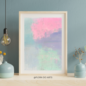 A framed abstract painting with soft, pastel colors of pink, green, and purple. The artwork features gentle brushstrokes and a serene blend of hues, set against a minimalist background with small decorative vases and a hanging light bulb nearby.